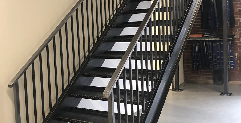 Commercial steel stair railing fabrication for interior staircase in a commercial building